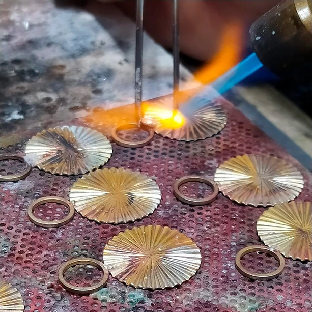Jewelry being created with a blowtorch
